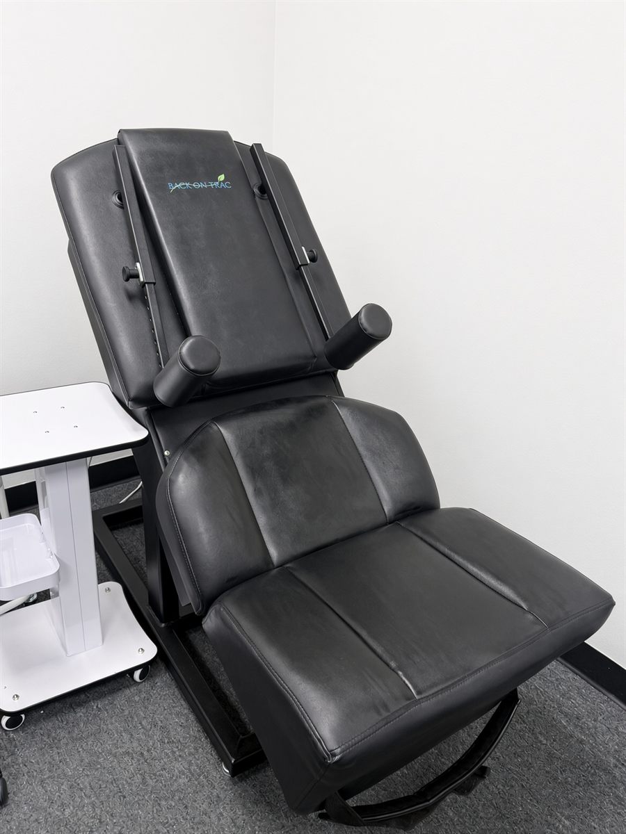 Back On Trac seated lumbar traction chair in a private room