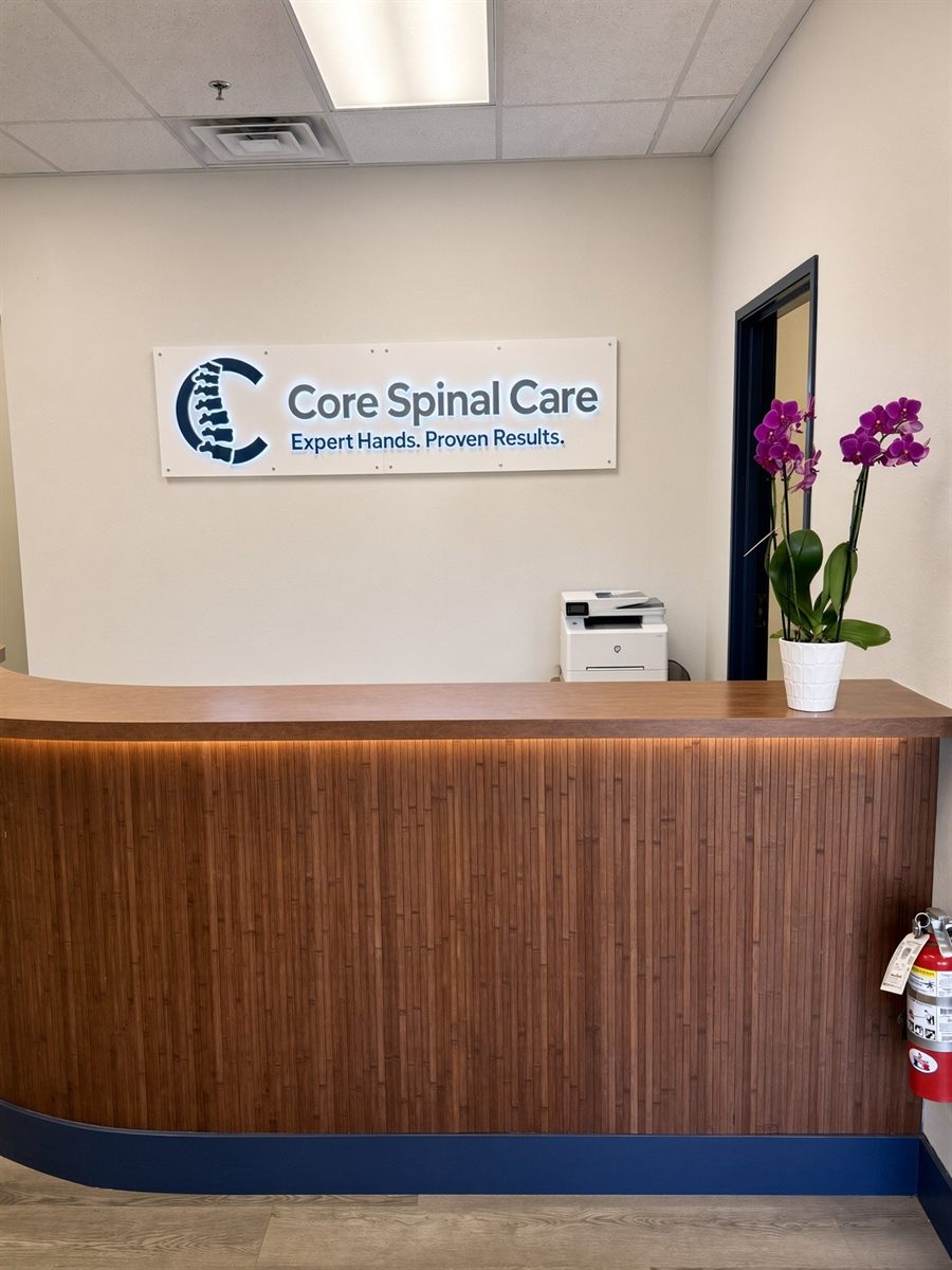 Reception desk under the illuminated Core Spinal Care sign