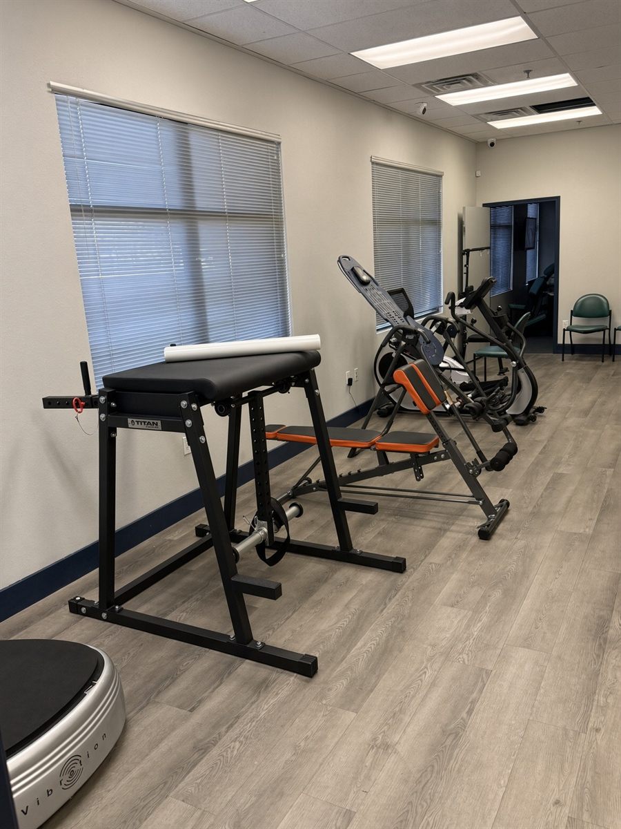 Rehab studio with Roman chair, inversion table, vibration plate and exercise bikes